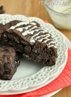 some brownies with white frosting on a plate next to a glass of milk