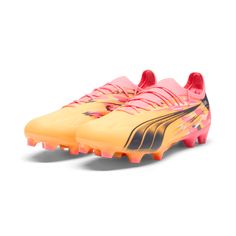 a pair of yellow and pink soccer shoes