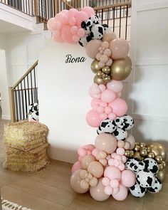 a bunch of balloons that are on the ground in front of a wall and stairs