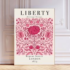 a poster with the words liberty written in red and pink, on a wooden floor