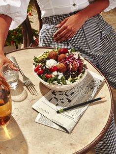 a person sitting at a table with a plate of food