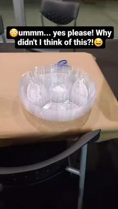 a plastic bowl sitting on top of a wooden table