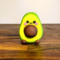 an avocado toy sitting on top of a wooden table