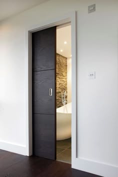 an open door leading to a bathroom with a tub