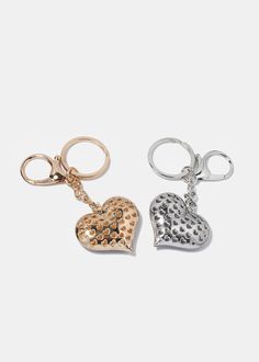 two heart shaped keychains on a white background, one is gold and the other is silver