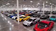 a large warehouse filled with lots of different colored sports cars