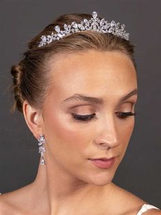 Classic CZ Wedding Tiara Our beautiful wedding tiara sparkles with AAAAA quality Cubic Zirconia stones. This classically designed wedding crown is plated in silver rhodium and has the perfect combination of understated elegance and dramatic sparkle. The design of the crown extends 9" around and measures 1 3/4" high at the center peak. You'll love the simple elegance of this sparkling headpiece. Size: About 1 3/4" high at center peak and 9" across. Color: Silver. Style: T4693.. Please allow 1 week for delivery. Shipping Policy . Return Policy Beaded Edge Veil, Quinceanera Accessories, Winter Wedding Accessories, Gold Bridesmaid Jewelry, Beaded Wedding Veils, Fingertip Wedding Veils, Rose Gold Tiara, Rose Gold Wedding Jewelry, Rose Gold Bridesmaid