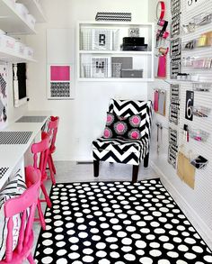 a black and white polka dot rug in a room with pink chairs on the floor