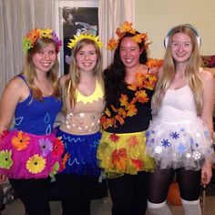 four girls dressed in costumes posing for the camera