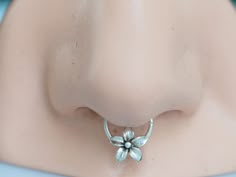 a close up view of a nose with a flower on it