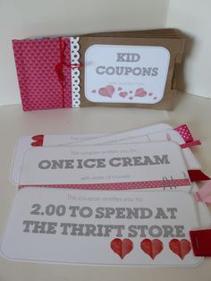 two coupons are sitting next to each other on a table with pink and red ribbons