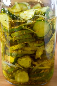 pickled cucumbers in a jar on a table