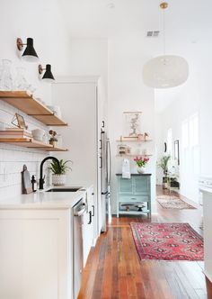 the kitchen is clean and ready for us to use it's wood flooring