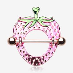 a pink brooch with green leaves on it