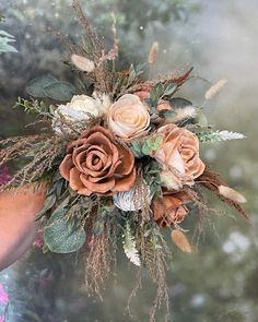 a woman holding a bouquet of flowers in her hand