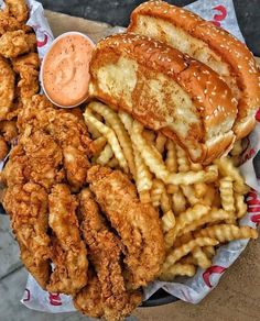 fried chicken, french fries and coleslaw on a paper plate