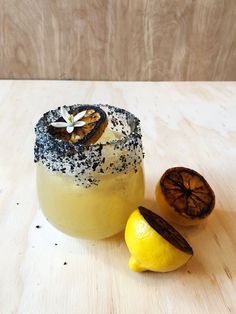 a lemon sitting next to a piece of fruit on top of a wooden countertop