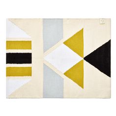 an area rug with different colors and shapes on the floor, including black, white, yellow, and blue