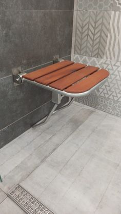 a wooden bench sitting on top of a tiled floor