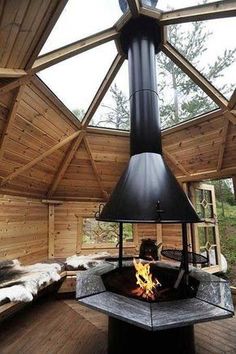 the inside of a wooden cabin with a fire place