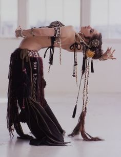 a belly dancer is posing for the camera