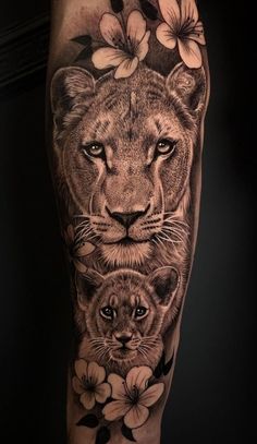 a lion and cub with flowers on their legs, done by tattoo artist marky