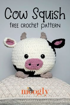 a crocheted cow stuffed animal sitting on top of a white pillow with the words cow squish free crochet pattern