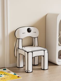 a white chair sitting next to a cardboard cutout of a dog on the floor