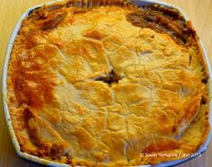 a pie sitting on top of a wooden table