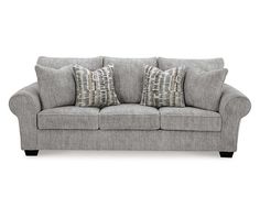 a gray couch with two pillows on it