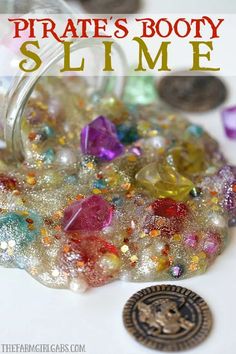 a jar filled with lots of different colored beads next to a coin on top of a table