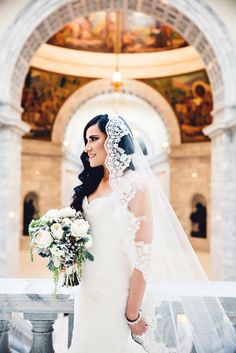 a woman in a wedding dress holding a bouquet