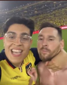 two men standing next to each other at a soccer game