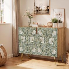 a sideboard with flowers and plants on it