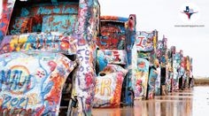 the trucks are covered in colorful graffiti on the water