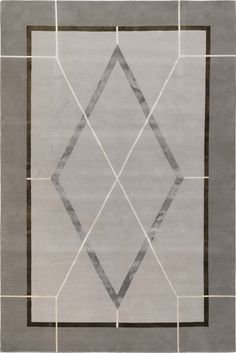 an area rug with grey and white designs on the front, in shades of gray