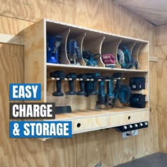 a wooden shelf filled with different types of power tools and drillers on top of it