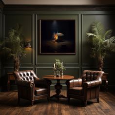 two leather chairs and a table in a room with green walls, potted palm trees and a painting on the wall