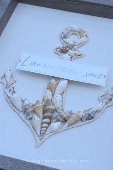 an anchor made out of seashells is displayed in a shadow box