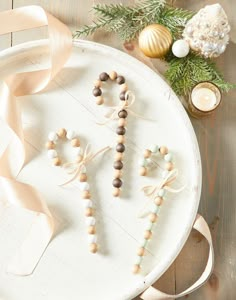 a white plate topped with wooden beads and decorations