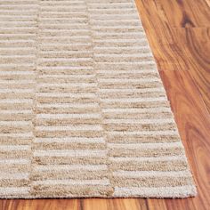 a close up of a rug on a wooden floor