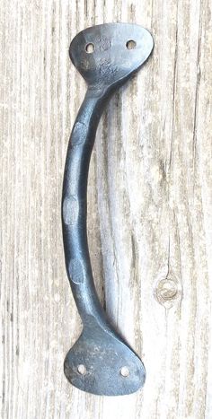 an old door handle on a wooden surface