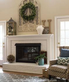 a living room filled with furniture and a fire place in front of a fireplace covered in wreaths