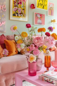 a living room filled with lots of pink and yellow flowers on top of a table