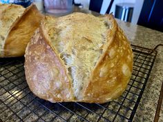 two loaves of bread sitting on top of a cooling rack