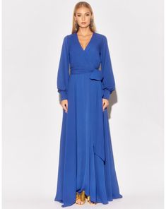 This 70's inspired maxi dress features a sexy cross front V-shaped surplice neckline. The elasticized waist adjusts to fit a range of sizes and has an attached self-tying belt at the right-hand side seam. The cuffed bell sleeves add a hint of retro glamour. The opaque fabric has a butter-soft hand with a vibrant, royal blue hue. The full, sweeping circle mid-length skirt is perfect for making a dramatic entrance to any event. The skirt is partially lined. ** Based on the settings of your display Plus Size White Jumpsuit, Circle Maxi Skirt, Trendy Plus Size Fashion, Retro Glamour, Dresses Royal, Medium Dress, Surplice Neckline, Mid Length Skirts, Chiffon Maxi