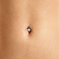 Introducing the gorgeous Crown Jewels Navel Ring—the ultimate accessory for your navel piercing. This luxurious belly ring is available with a selection of stunning natural gemstones. Choose from natural opals, amethyst, and rose quartz, and add a touch of regal elegance to your belly piercing. Each belly button ring is meticulously crafted to ensure unparalleled brilliance and to last a lifetime. Top gems measure 3mm each Bottom gem measures: 8mm (7mm for Black Opal) Natural Gemstones Solid 14k Belly Button Piercing Hoop, Bottom Belly Button Piercing, Opal Belly Ring, Amethyst And Rose Quartz, Regal Elegance, Navel Ring, Piercing Ring, Navel Piercing, Belly Piercing