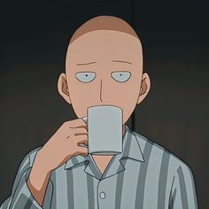 a man holding a coffee cup in front of his face