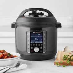 an open crock pot next to a plate of food