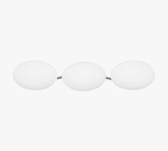 three white balls are sitting on top of each other in front of a white background